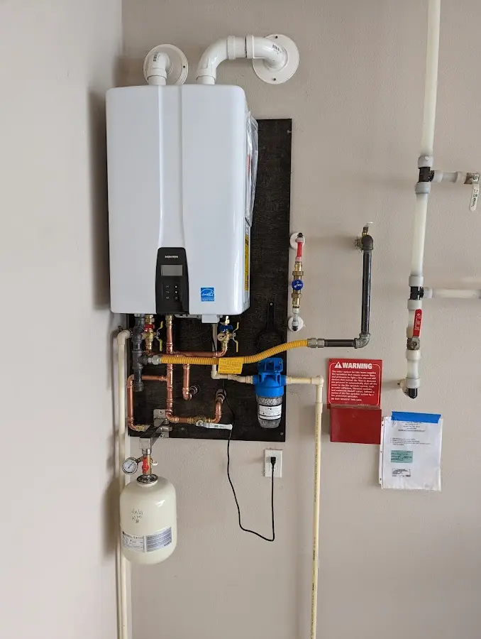 Professional plumber installing copper piping in a Amelia home